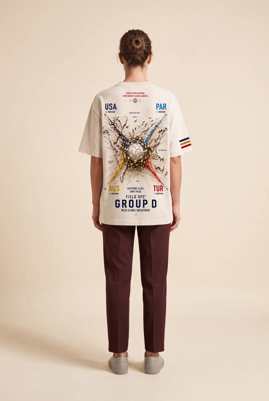 Group D tee worn on model, studio back.